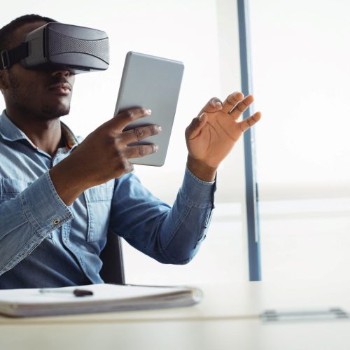 business-executive-using-virtual-reality-headset-digital-tablet TELECOMMUNICATIONS