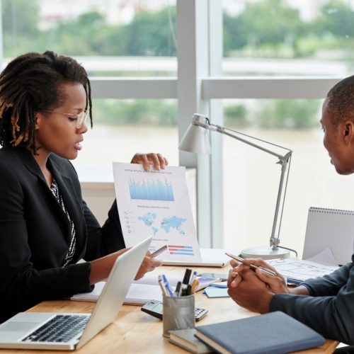 side-view-businesswoman-showing-analytical-charts-her-male-coworker side-view-businesswoman-showing-analytical-charts-her-male-coworker